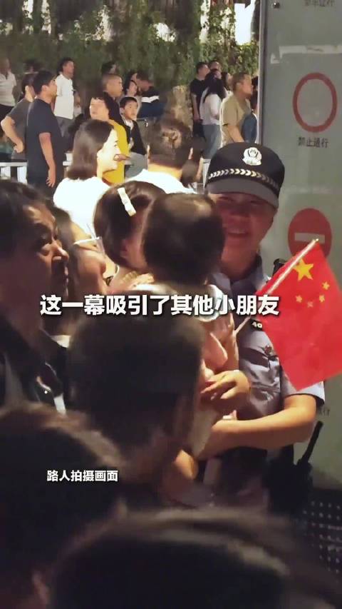 【#15万人广场上她把孩子交给女警#】#女警怕警灯闪到孩子眼睛用手挡住# 10月1日晚，云南玉溪，1